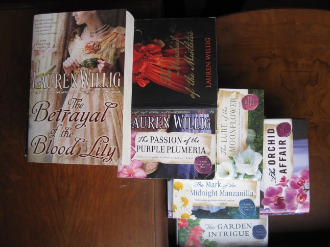 Pink Carnation books in a pile