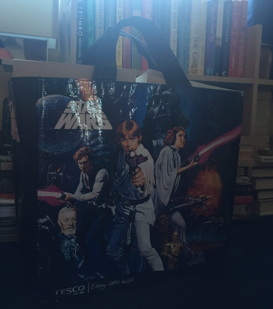 A bag of books in front of a bookshelf