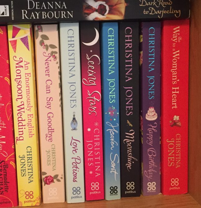 A selection of books by Christina Jones on a bookshelf.