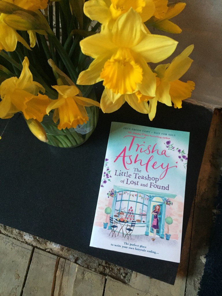 Trisha Ashley's Little Teashop of Lost and Found and some daffodils.