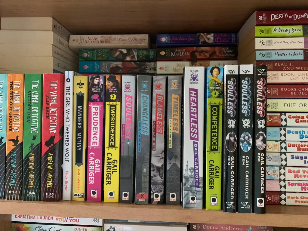 Shelf of Gail Carriger books of varying sizes