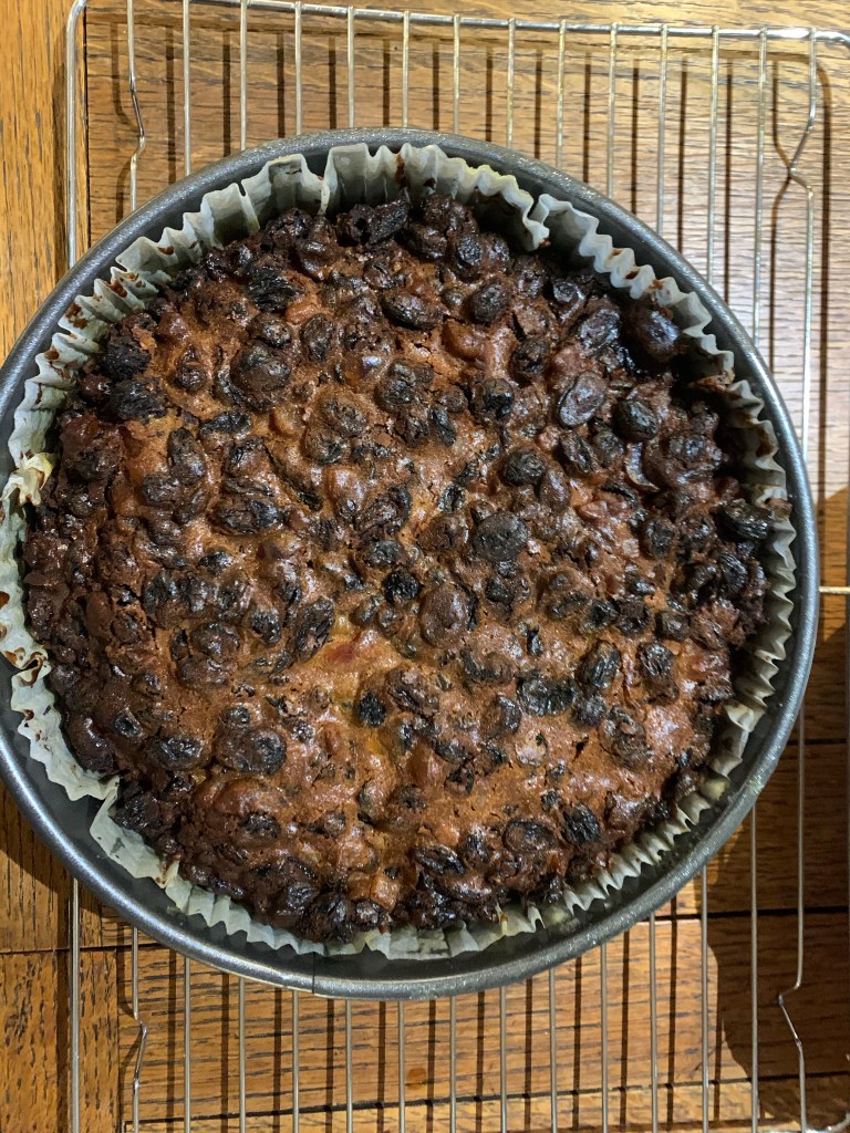 A christmas cake on a cooling rack